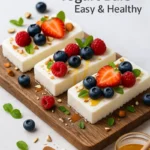 Frozen Greek Yogurt Bars: Irresistible, Healthy, and Easy Treats Everyone Loves 7 Frozen Greek yogurt bars on marble with berries and almonds