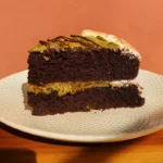 Chocolate pistachio kataifi cake with crisp pastry and ganache on plate