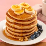 Cottage cheese banana pancakes on plate with syrup