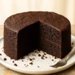 Whole vegan chocolate cake on stand