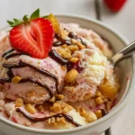 Scoops of strawberry and peanut butter cottage cheese ice cream in a bowl